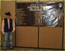 scholarship winner Kyle Coburn in front of donor banner.jpg